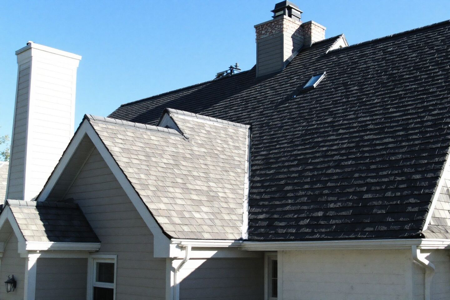 Shingle roof with gables, a chimney and a skylight